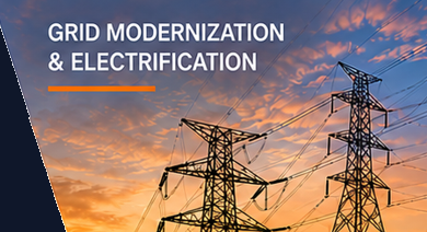 High-voltage transmission towers at sunset — grid modernization and electrification
